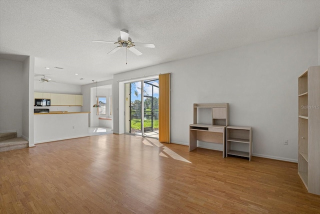 9528 Knightsbridge Cir, Sarasota, FL 34238 - unfurnished living room with ceiling fan, wood finished floors, and a textured ceiling