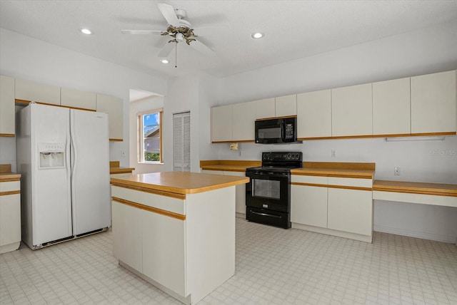 9528 Knightsbridge Cir, Sarasota, FL 34238 - kitchen featuring black appliances, cream cabinetry, a ceiling fan, light countertops, and a center island