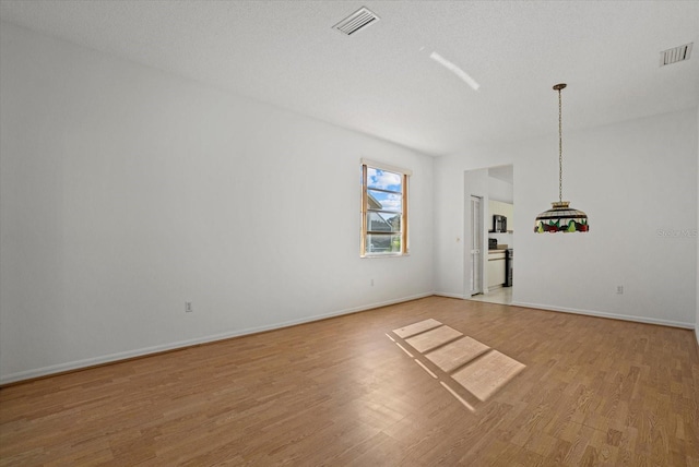 9528 Knightsbridge Cir, Sarasota, FL 34238 - unfurnished living room featuring light wood finished floors and baseboards