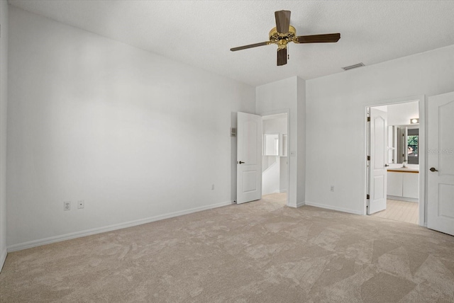 9528 Knightsbridge Cir, Sarasota, FL 34238 - unfurnished bedroom with light colored carpet, connected bathroom, and a ceiling fan