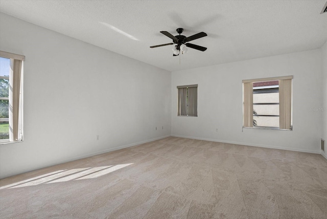 9528 Knightsbridge Cir, Sarasota, FL 34238 - carpeted empty room with healthy amount of natural light, a ceiling fan, and a textured ceiling