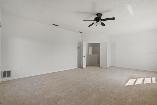 9528 Knightsbridge Cir, Sarasota, FL 34238 - empty room with light carpet, a ceiling fan, and a textured ceiling