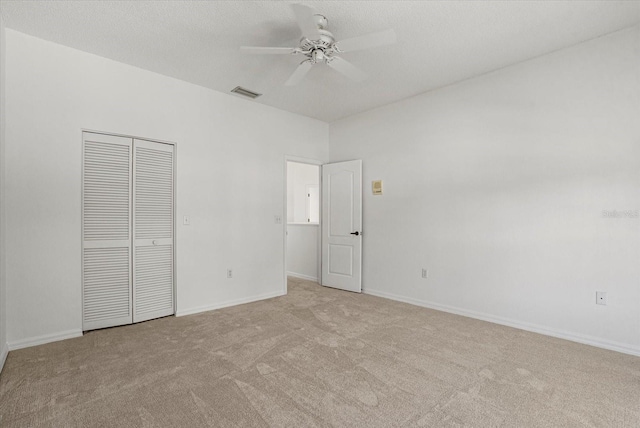 9528 Knightsbridge Cir, Sarasota, FL 34238 - unfurnished bedroom with light carpet, a closet, and ceiling fan