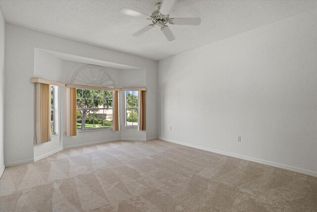 9528 Knightsbridge Cir, Sarasota, FL 34238 - carpeted empty room featuring a textured ceiling and ceiling fan