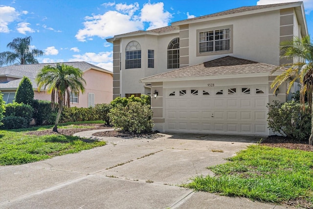 9528 Knightsbridge Cir, Sarasota, FL 34238 - view of front of house featuring stucco siding and concrete driveway