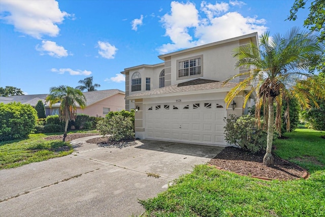9528 Knightsbridge Cir, Sarasota, FL 34238 - view of front facade featuring stucco siding, driveway, and an attached garage