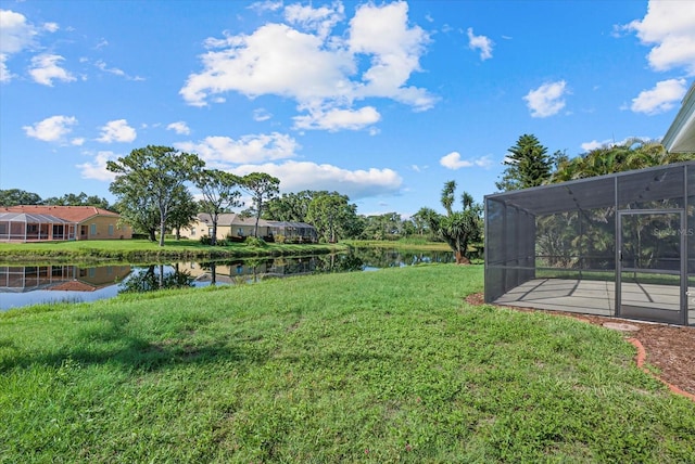 9528 Knightsbridge Cir, Sarasota, FL 34238 - view of green lawn with a water view and a lanai