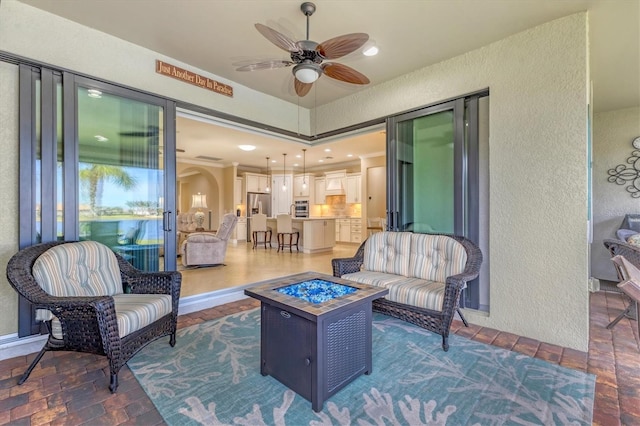 13334 Pacchio St, Venice, FL 34293 - view of patio featuring a ceiling fan and an outdoor living space with a fire pit