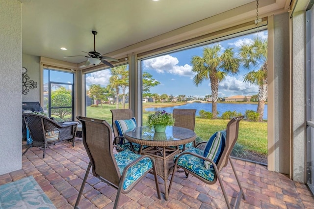 13334 Pacchio St, Venice, FL 34293 - sunroom with a water view, a ceiling fan, outdoor dining space, a textured wall, and recessed lighting