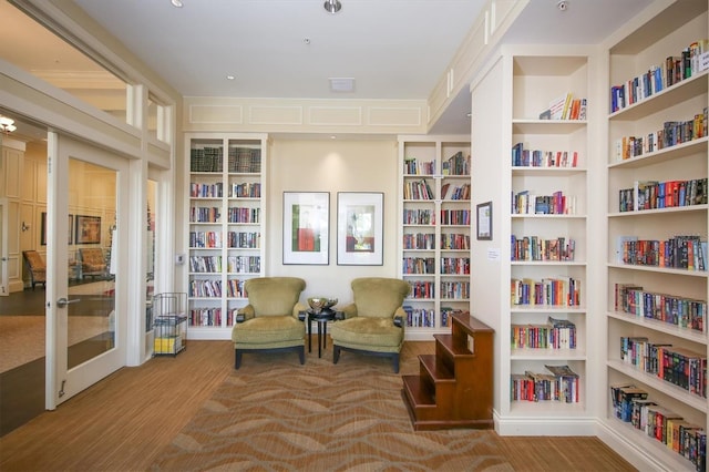 13334 Pacchio St, Venice, FL 34293 - living area featuring bookshelves, wood finished floors, and built in shelves