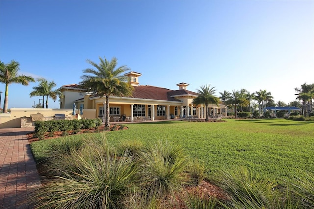 13334 Pacchio St, Venice, FL 34293 - back of property with a lawn, stucco siding, and a tiled roof