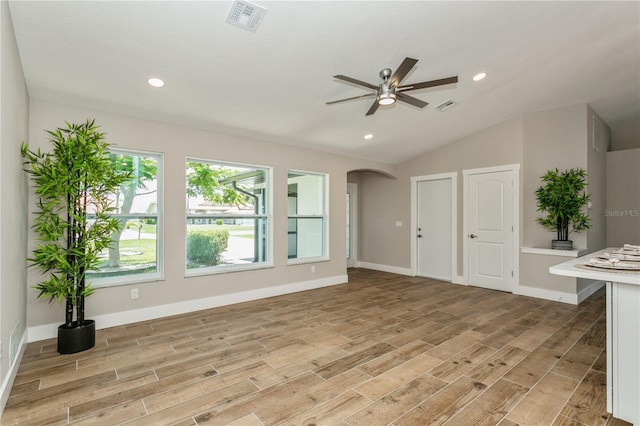 26115 Rampart Blvd, Punta Gorda, FL 33983 - unfurnished living room with light wood-style flooring, a ceiling fan, arched walkways, recessed lighting, and vaulted ceiling