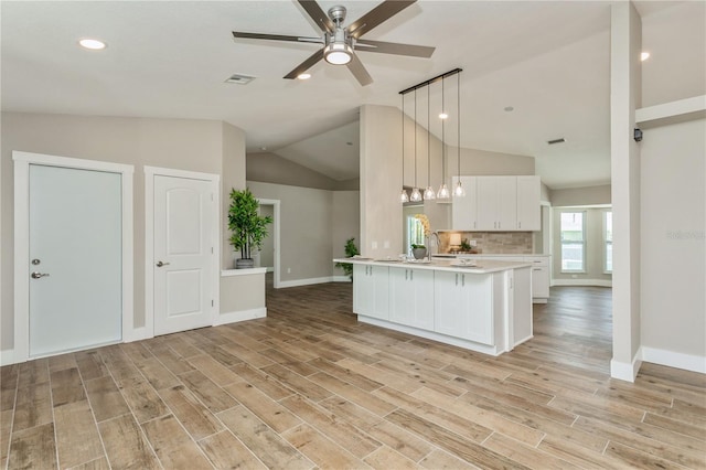 26115 Rampart Blvd, Punta Gorda, FL 33983 - kitchen featuring light countertops, white cabinets, lofted ceiling, ceiling fan, and light wood finished floors
