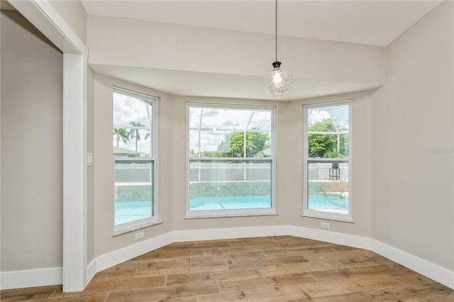 26115 Rampart Blvd, Punta Gorda, FL 33983 - unfurnished dining area featuring baseboards and light wood-style floors