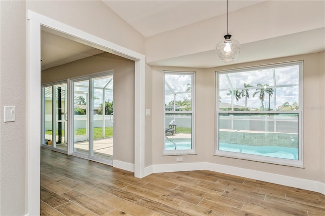 26115 Rampart Blvd, Punta Gorda, FL 33983 - unfurnished dining area featuring wood finished floors and lofted ceiling