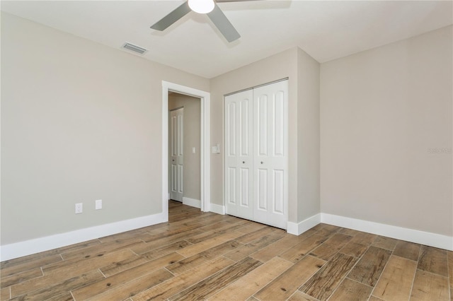 26115 Rampart Blvd, Punta Gorda, FL 33983 - unfurnished bedroom featuring wood finished floors, a closet, and ceiling fan