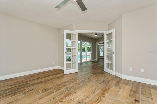 26115 Rampart Blvd, Punta Gorda, FL 33983 - empty room with french doors, ceiling fan, and light wood finished floors