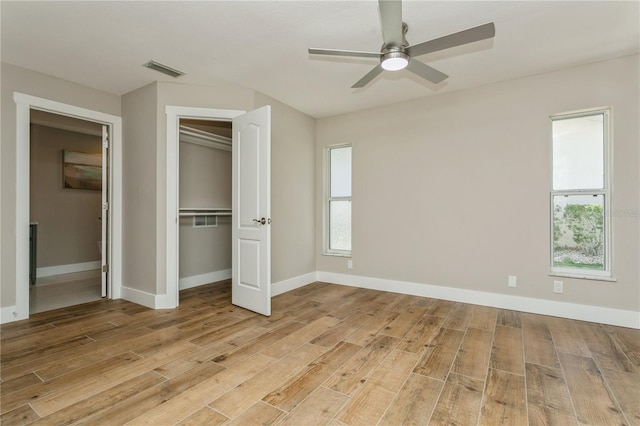 26115 Rampart Blvd, Punta Gorda, FL 33983 - unfurnished bedroom featuring light wood-type flooring, multiple windows, a closet, and ceiling fan