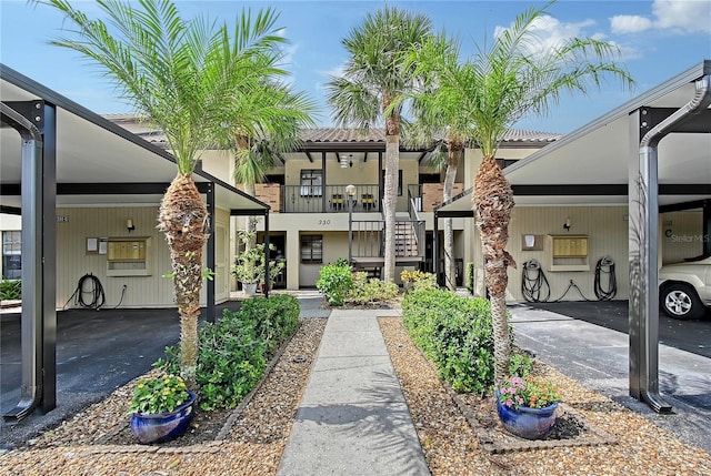 330 Mission Trl N Unit F, Venice, FL 34285 - view of front facade with a tile roof and a carport