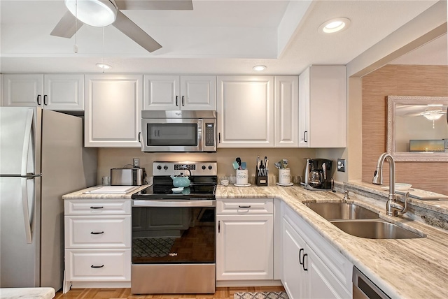 330 Mission Trl N Unit F, Venice, FL 34285 - kitchen with appliances with stainless steel finishes, ceiling fan, white cabinets, recessed lighting, and light stone counters