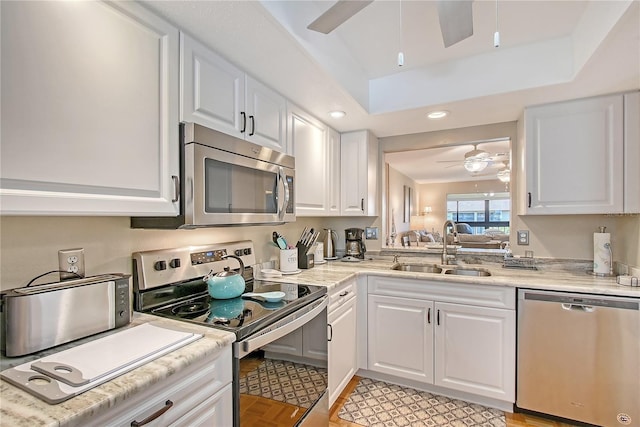 330 Mission Trl N Unit F, Venice, FL 34285 - kitchen with stainless steel appliances, ceiling fan, light countertops, white cabinets, and recessed lighting
