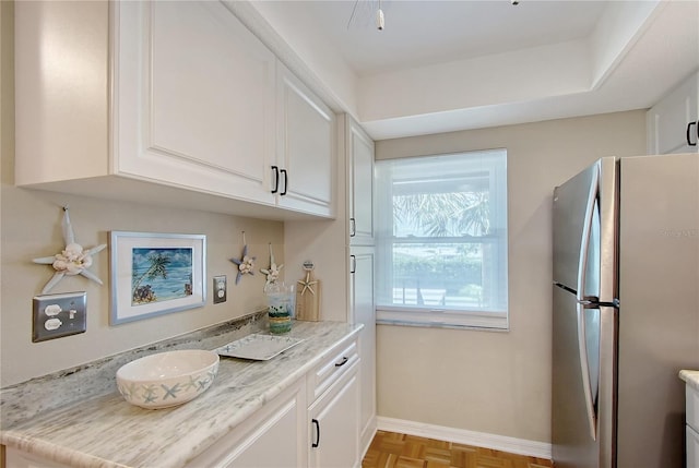 330 Mission Trl N Unit F, Venice, FL 34285 - kitchen with freestanding refrigerator, white cabinets, and light countertops