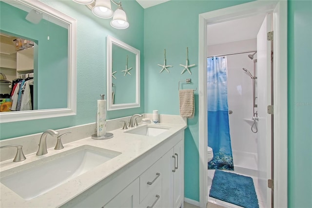 330 Mission Trl N Unit F, Venice, FL 34285 - bathroom featuring double vanity, a shower with shower curtain, and a spacious closet