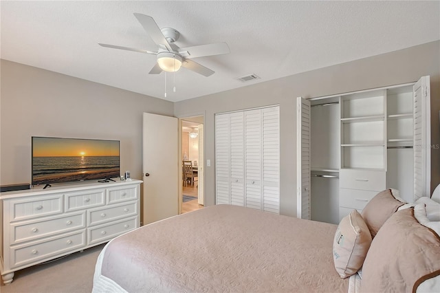 330 Mission Trl N Unit F, Venice, FL 34285 - carpeted bedroom with multiple closets and ceiling fan