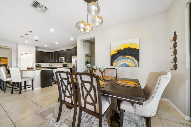 23527 Awabuki Unit 202, Venice, FL 34293 - dining area featuring light tile patterned flooring, a chandelier, and recessed lighting