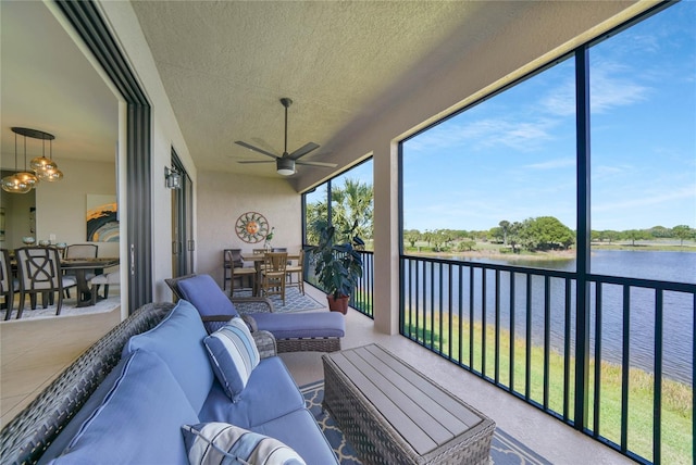 23527 Awabuki Unit 202, Venice, FL 34293 - sunroom / solarium featuring a water view, outdoor lounge area, ceiling fan, outdoor dining space, and a textured ceiling
