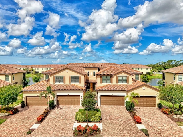 12590 Ghiberti Cir Unit 201, Venice, FL 34293 - mediterranean / spanish-style home featuring stucco siding, driveway, a tiled roof, and a residential view