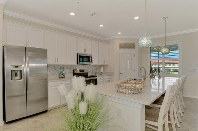 12590 Ghiberti Cir Unit 201, Venice, FL 34293 - kitchen featuring stainless steel appliances, white cabinets, tasteful backsplash, ornamental molding, and recessed lighting