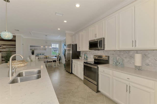 12590 Ghiberti Cir Unit 201, Venice, FL 34293 - kitchen featuring stainless steel appliances, ornamental molding, tasteful backsplash, white cabinets, and light tile patterned floors