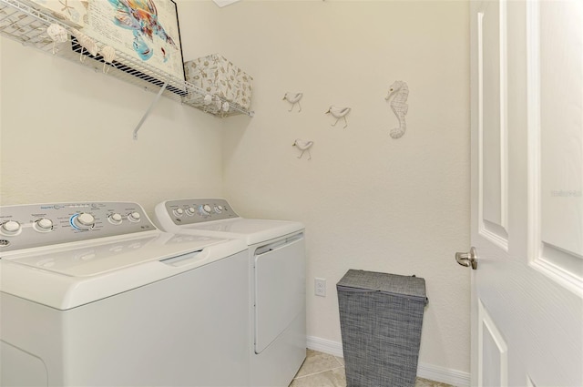12590 Ghiberti Cir Unit 201, Venice, FL 34293 - laundry area with separate washer and dryer and light tile patterned floors