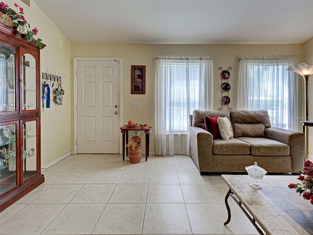 3139 Point St, North Port, FL 34286 - living room featuring light tile patterned flooring and baseboards
