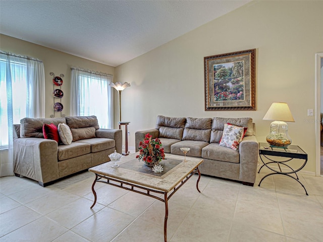 3139 Point St, North Port, FL 34286 - living room featuring light tile patterned flooring, vaulted ceiling, and a textured ceiling