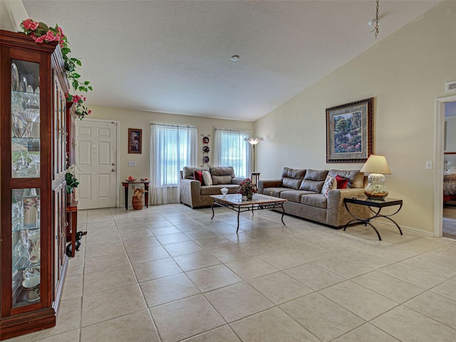 3139 Point St, North Port, FL 34286 - living area featuring lofted ceiling, light tile patterned flooring, and a textured ceiling