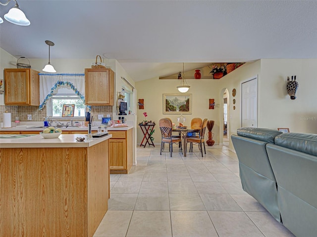 3139 Point St, North Port, FL 34286 - kitchen featuring decorative backsplash, light countertops, arched walkways, vaulted ceiling, and open floor plan
