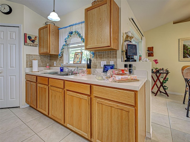 3139 Point St, North Port, FL 34286 - kitchen with light tile patterned floors, backsplash, lofted ceiling, light countertops, and decorative light fixtures