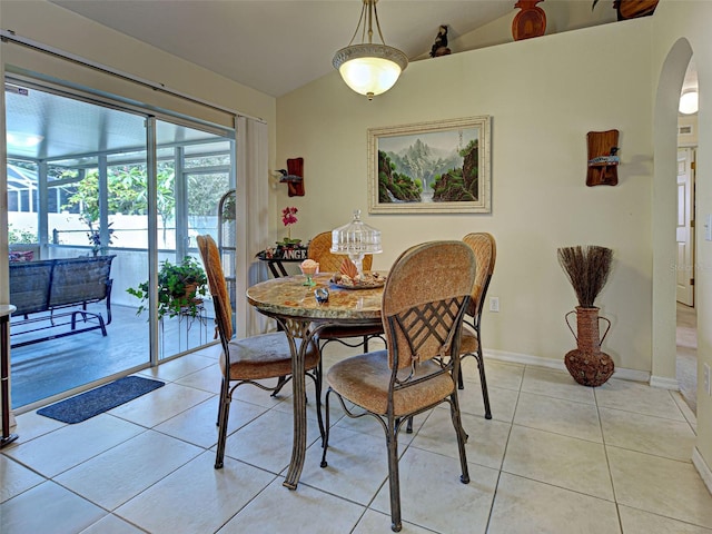 3139 Point St, North Port, FL 34286 - dining room with vaulted ceiling, light tile patterned flooring, and arched walkways