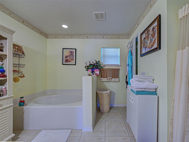 3139 Point St, North Port, FL 34286 - full bath featuring a textured ceiling, a bath, tile patterned floors, and recessed lighting