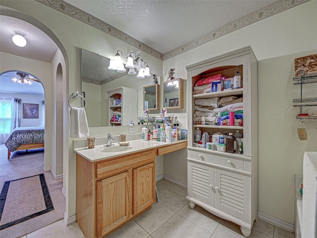 3139 Point St, North Port, FL 34286 - ensuite bathroom with vanity, a textured ceiling, and tile patterned floors
