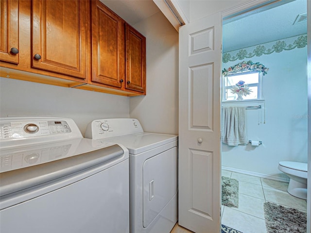 3139 Point St, North Port, FL 34286 - washroom featuring washing machine and dryer, cabinet space, and light tile patterned floors