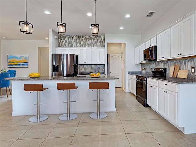 9157 Genesee St, Port Charlotte, FL 33981 - kitchen with black electric range oven, stainless steel fridge, decorative backsplash, a kitchen bar, and recessed lighting