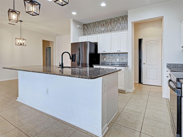9157 Genesee St, Port Charlotte, FL 33981 - kitchen featuring stainless steel fridge with ice dispenser, range with electric stovetop, light tile patterned floors, dark stone countertops, and recessed lighting