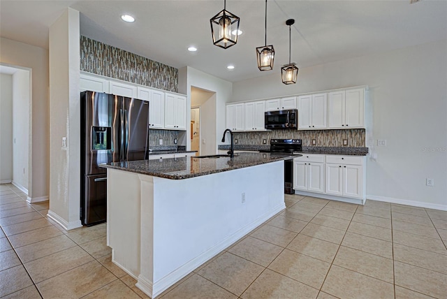 9157 Genesee St, Port Charlotte, FL 33981 - kitchen with black microwave, stainless steel fridge with ice dispenser, light tile patterned floors, tasteful backsplash, and a kitchen island with sink