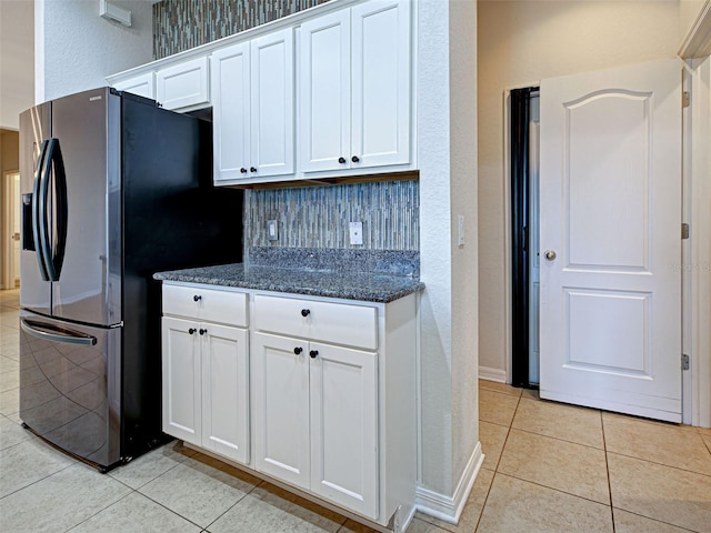 9157 Genesee St, Port Charlotte, FL 33981 - kitchen featuring light tile patterned floors, white cabinets, dark stone counters, and fridge with ice dispenser