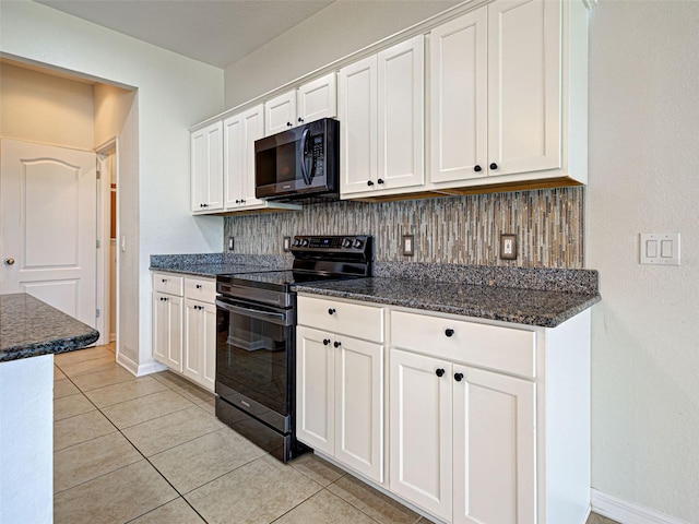 9157 Genesee St, Port Charlotte, FL 33981 - kitchen with black range with electric cooktop, tasteful backsplash, white cabinets, and light tile patterned flooring
