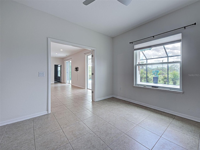 9157 Genesee St, Port Charlotte, FL 33981 - empty room with light tile patterned floors and a ceiling fan