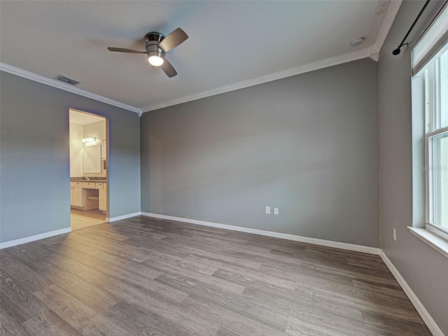 9157 Genesee St, Port Charlotte, FL 33981 - spare room featuring a ceiling fan, ornamental molding, plenty of natural light, and wood finished floors